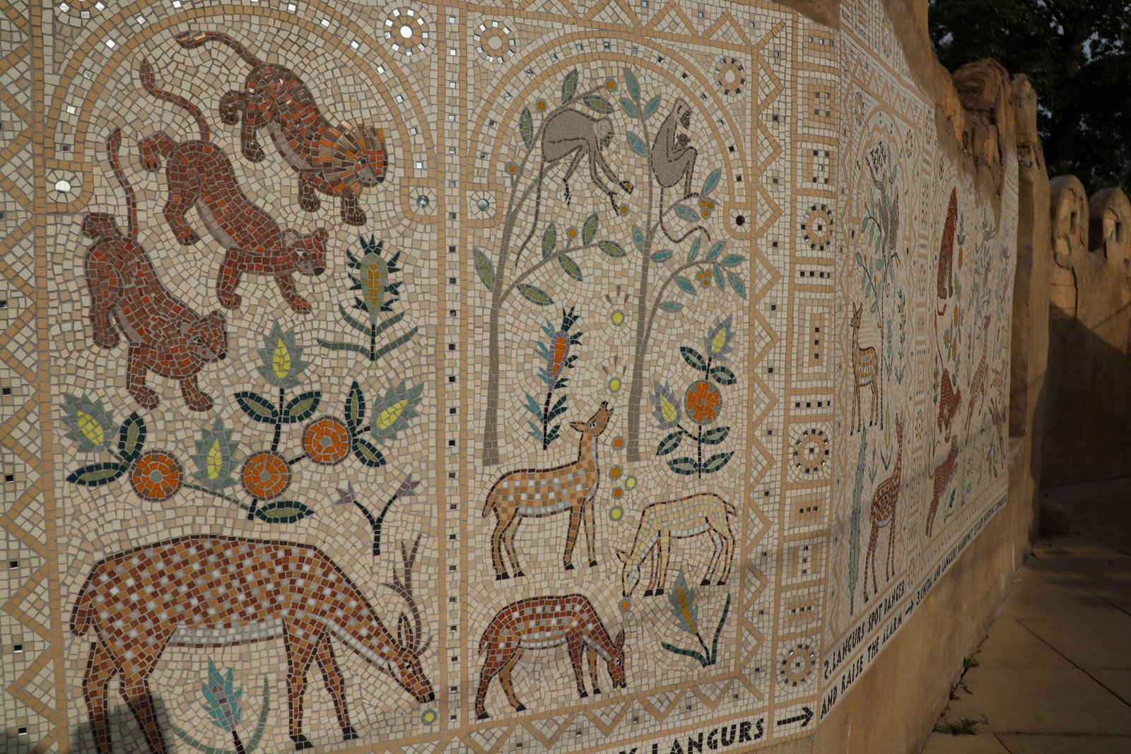 A finely tiled mosaic at London Zoo, showing animals on an off-white background